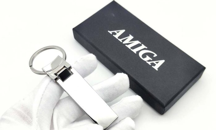 Amiga Metal Keychain next to its elegant black presentation box with logo