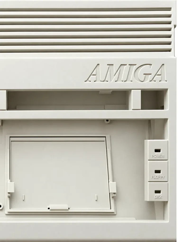 Amiga 600 Case Shell Detail Close view of the Amiga 600 top shell: ribbed vents, embossed AMIGA lettering and the power, floppy and disk LED panel